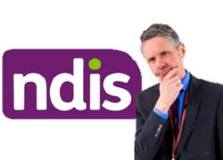 A man in suit thinking about ndis
